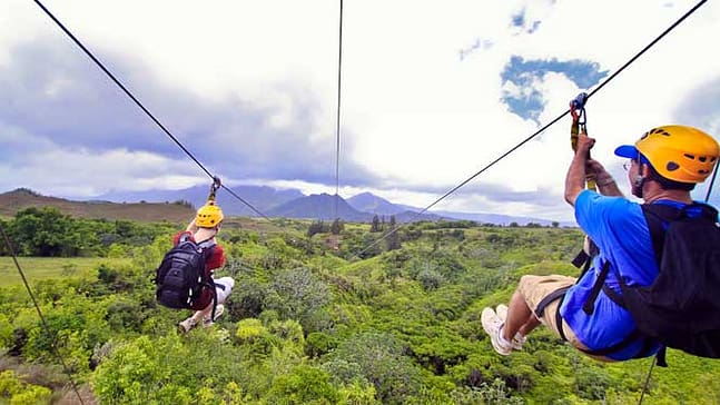 Two people ziplining with a beatifull background