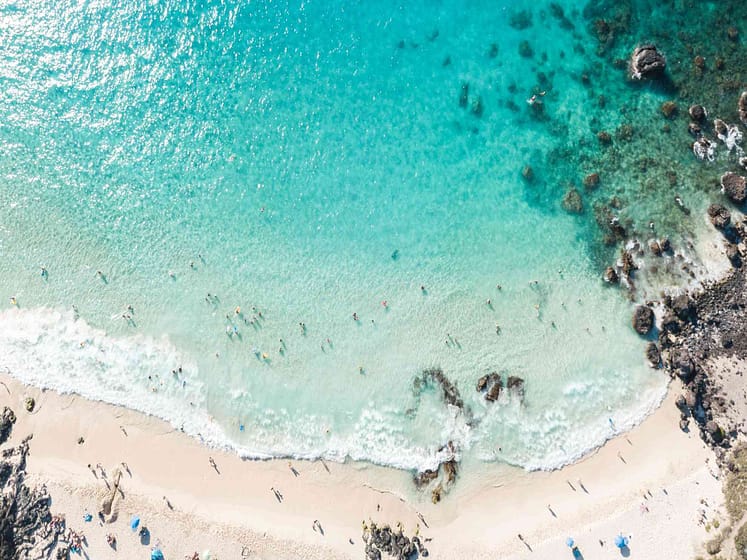 Kailua-Kona Beach from above with people in water and on beach