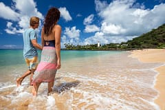 Couple walking on white sand beach of Waimea Bay, Oahu