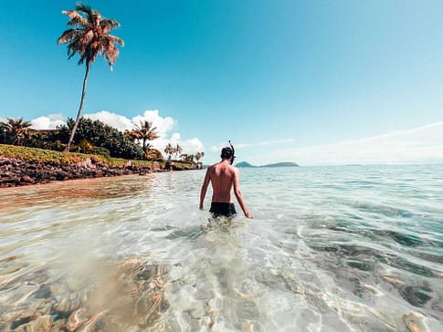 Man snorkeling in Hawaii from beach in Honolulu