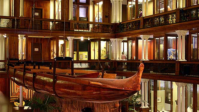 Inside the Bishop Museum looking at a canoe