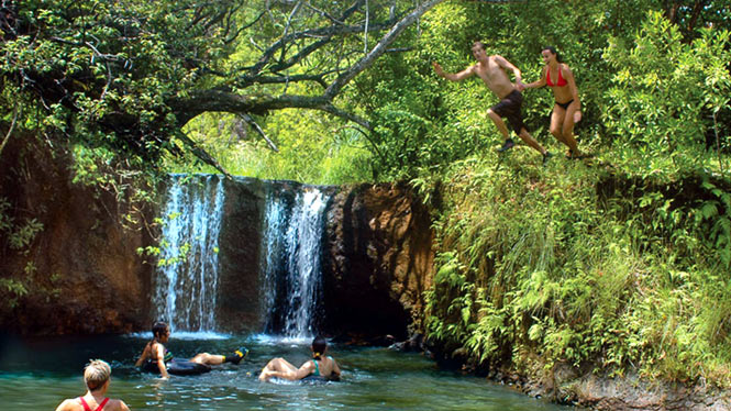 Swimming in a secluded water holw with a small waterfall