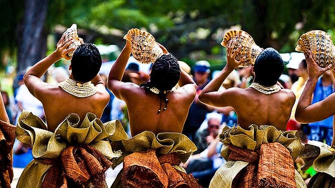 Hula dancers with conch shell kicking off the Aloha Festivals